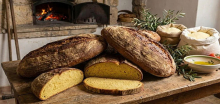  Sliced ​​country bread from Custonaci, a town in northwestern Sicily, in front of flickering flames in a wood-fired oven